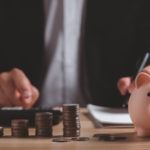 Man counting coins from a piggy bank