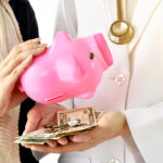 doctor-holding-piggy-bank