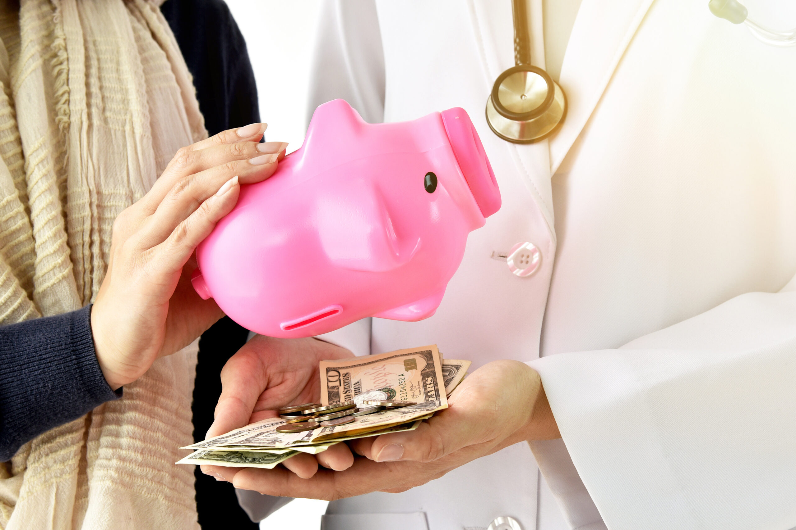 doctor-holding-piggy-bank